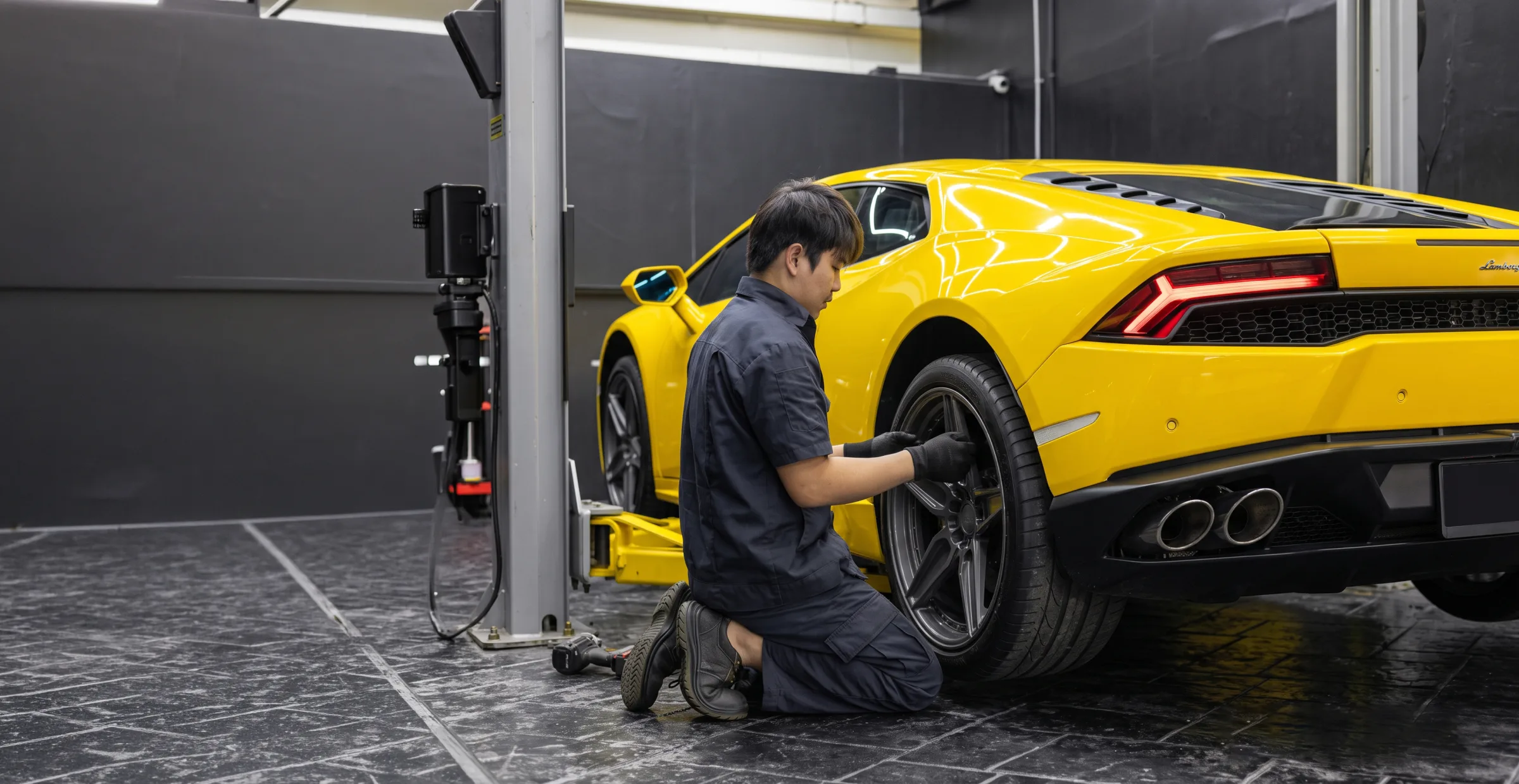 A Flinstone Autoparts technician fitting wheels to a Lamborghini Huracan