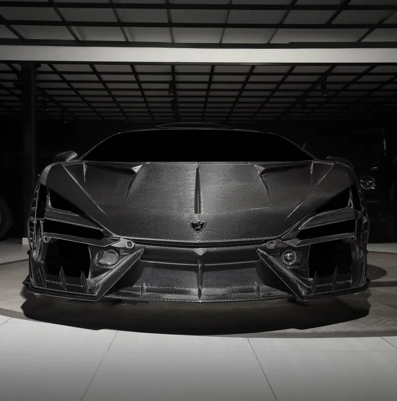 Front of a Lamborghini Revuelto with TOPCAR R’Evo Carbon Edition body kit and carbon fiber front bumper