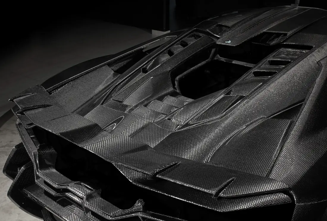 Close-up of the carbon fiber engine cover on a Lamborghini Revuelto with TOPCAR R’Evo Carbon Edition body kit