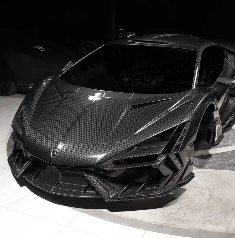 Front of a Lamborghini Revuelto with TOPCAR R’Evo Stealth Edition body kit and carbon fiber front bumper