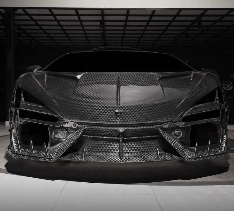 Front three-quarter view of a Lamborghini Revuelto with TOPCAR R’Evo Stealth Edition carbon kit
